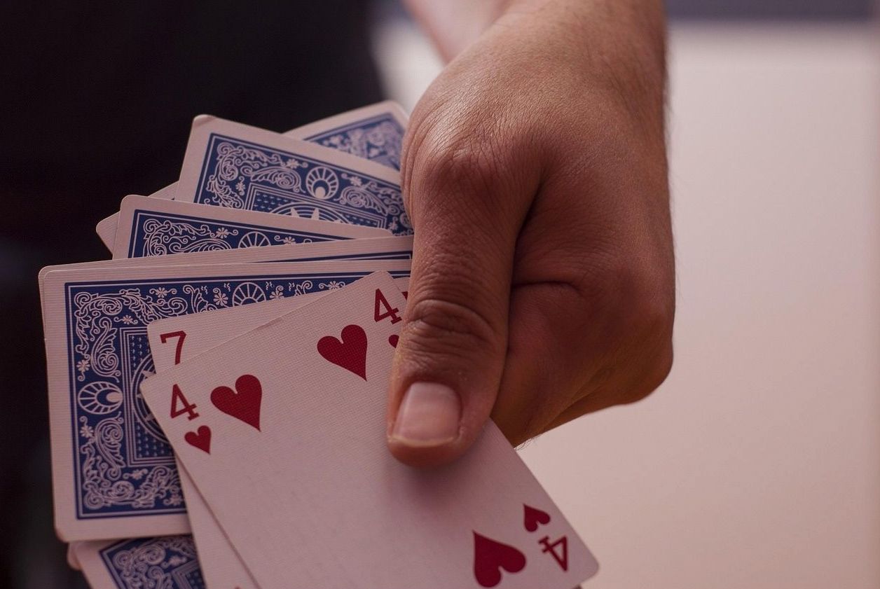 Guest holding cards during a hosted session