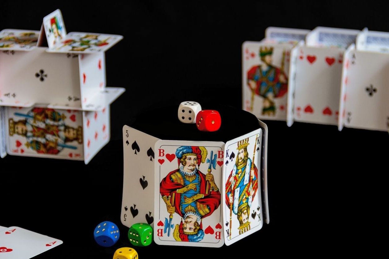 Playful card houses and dice — trivia club mood